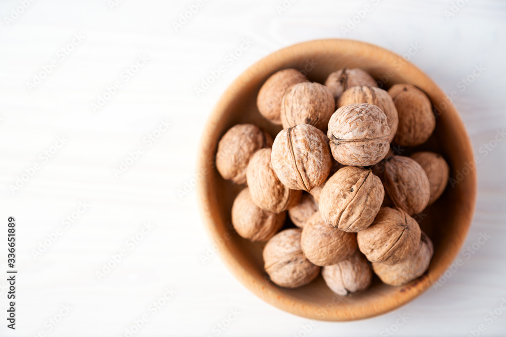 walnuts in a wooden bowl walnuts in a wooden bowl