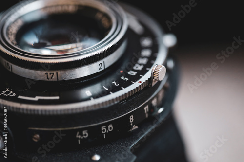 Macro and shallow depth of field image (selective focus) with the markings on the lens of a very old bellows photo camera (exposure time and f-stops).