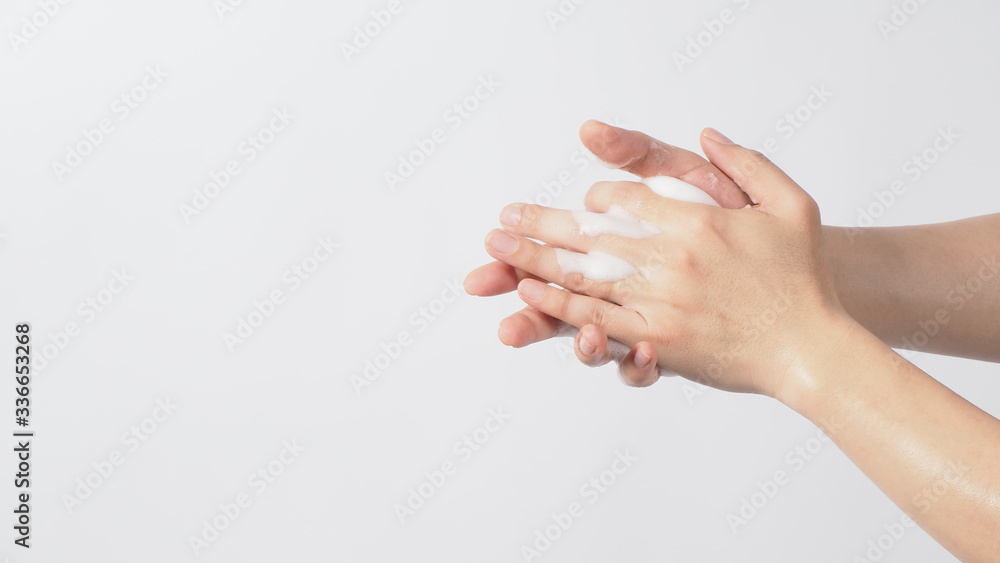 Hands washing gesture with foaming hand soap on white background.