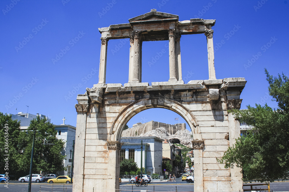 Ancient gate in Athens with city streets