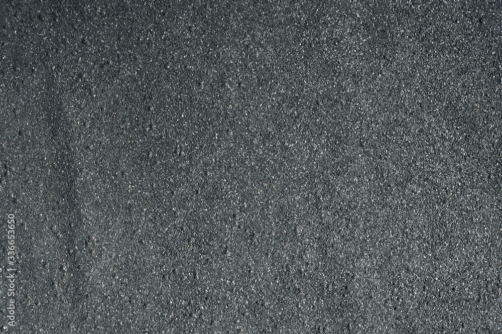 Bitumen roof texture. Black asphalt surface. Grey road granular material Bitumen roof texture. Black asphalt surface. Grey road granular material