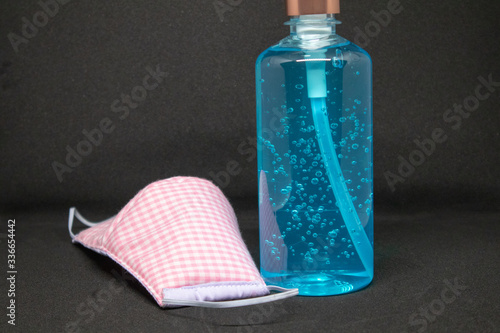 Blue hand sanitizer and gag  mask used to prevent the virus from ovid -19 photo