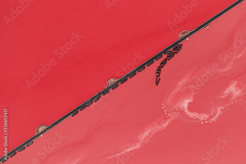 Aerial drone top-down photo of a beautiful natural pink lake located in Torrevieja, Spain. The lake turning into pink by a natural phenomenon and because it has high concentration of salt and algae