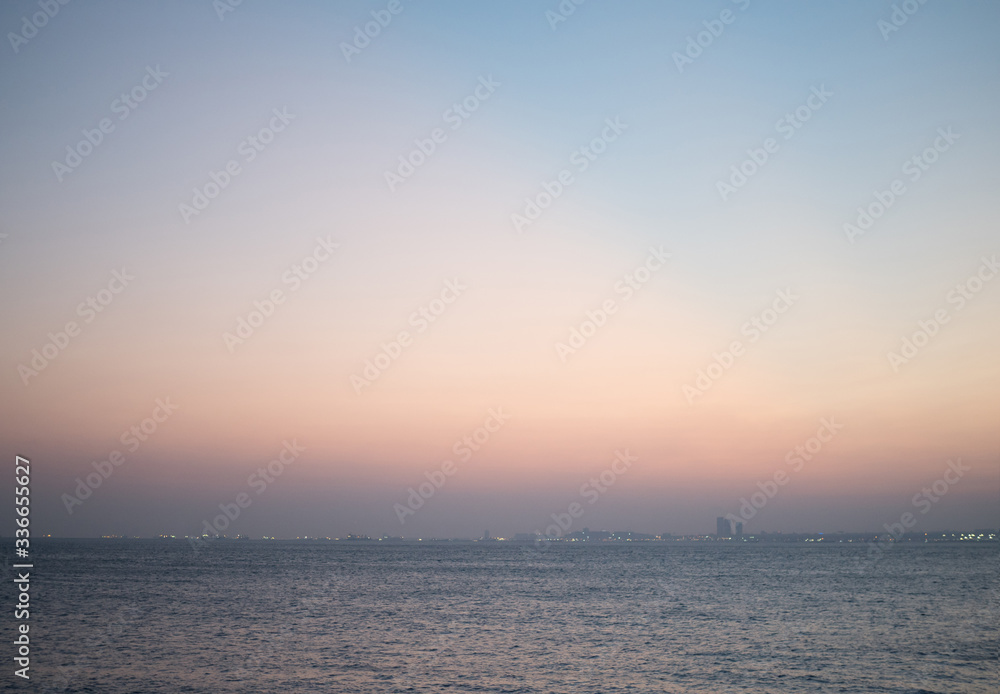 Simple bokeh background with misty sky in the evening and waves in the sea