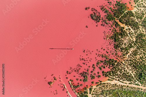 Aerial drone top-down photo of a beautiful natural pink lake located in Torrevieja, Spain. The lake turning into pink by a natural phenomenon and because it has high concentration of salt and algae