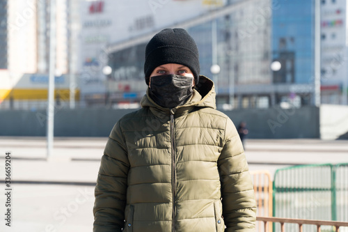 masked girl stands coronavirus quarantine on the street at home photo