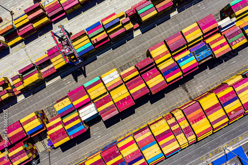 Aerial drone top-down photo of a container port at shipping dock in Valencia, Spain. containers lined to be loaded on the ship to be exported and import containers are received on the port