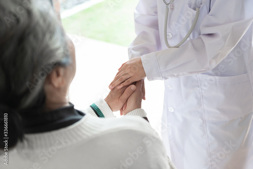 Young family doctor is talking with seniors