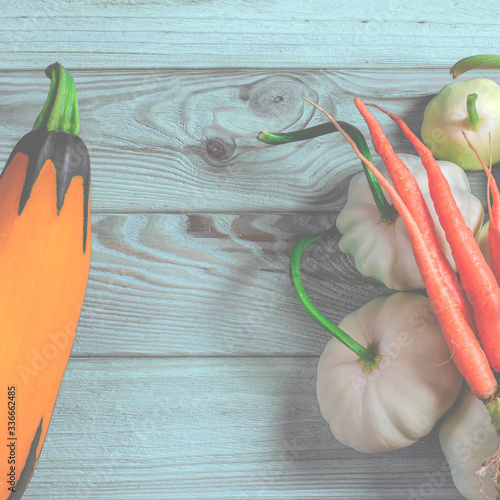 Vegetable set: carrots, patisons with green tails and multi-colored zucchini lie on an old wooden table photo