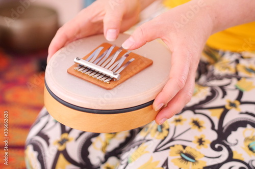 Close up of a sansula sound instrument played during a sound healing therapy healing session.  photo