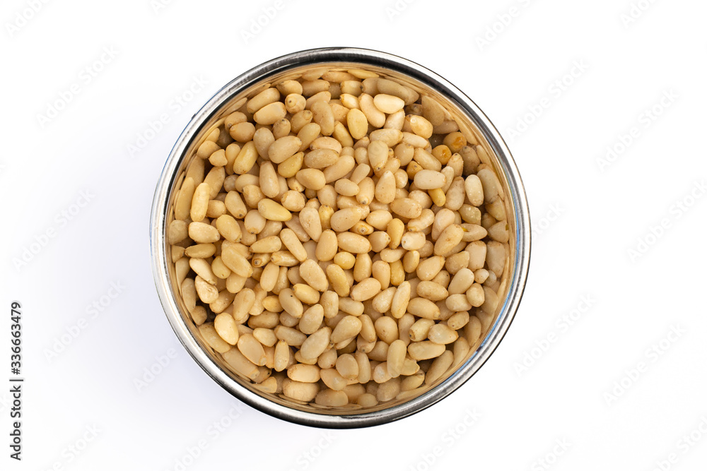 Pine Nuts in Stainless Steel bowl isolated on a white background, cooking ingredient and garnish. Closeup detail, delicious raw seed. Pine Nuts in Stainless Steel bowl isolated on a white background, cooking ingredient and garnish. Closeup detail, delicious raw seed.