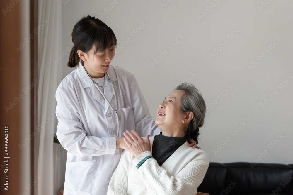 Fototapeta premium Young family doctor is talking with seniors