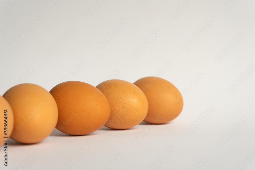 Five fresh brown chicken eggs in a row diagonally on grey background. Easter holiday Five fresh brown chicken eggs in a row diagonally on grey background. Easter holiday