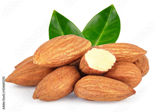 Almond nuts heap with green leaves