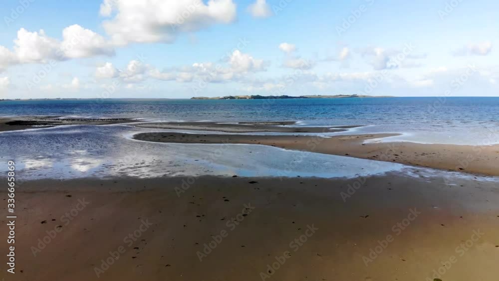 Aerial view flying across the sea in Sejerøbugten with flying seabirds and beautiful sandbanks Aerial view flying across the sea in Sejerøbugten with flying seabirds and beautiful sandbanks