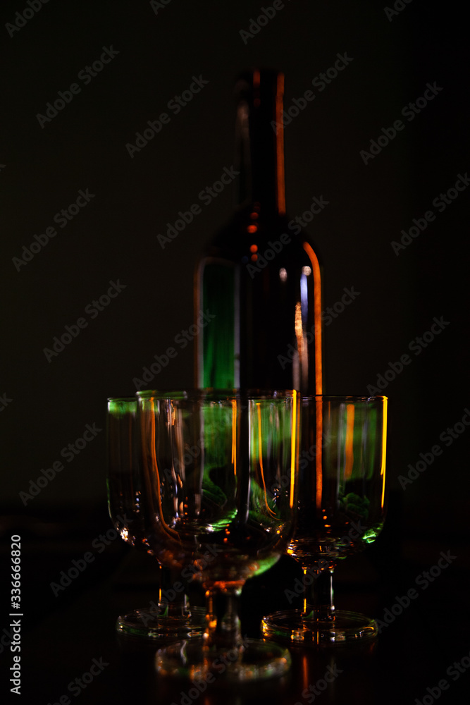 bottle and glasses on the bar