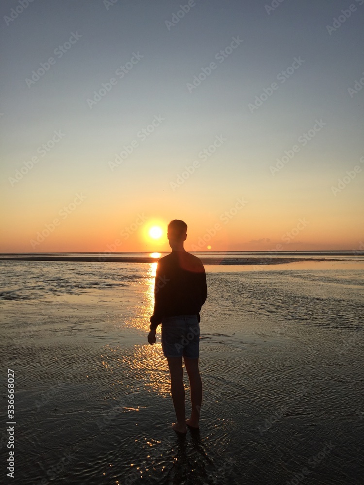 man on the beach at sunset