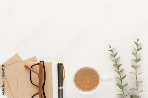 Envelope glasses pen coffee cab modern business background with copy space for your text. Top view, flat lay.