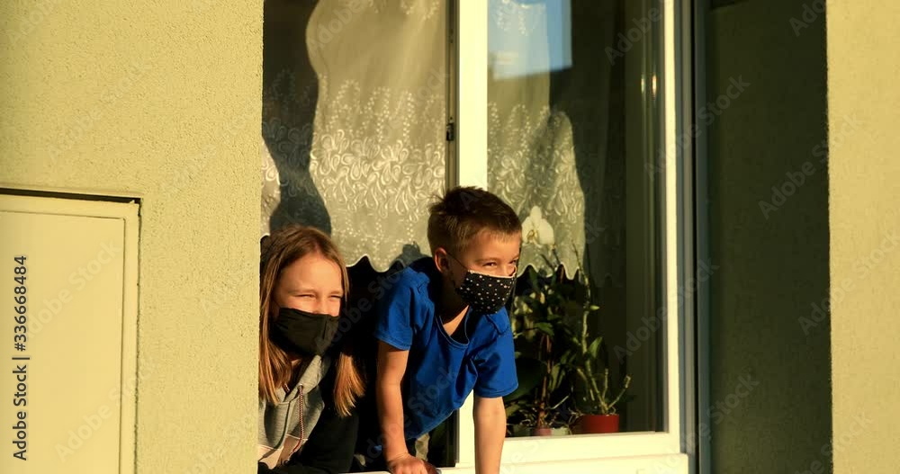 Covid 19. Children in window with masks.
Boy and girl with face protection are looking out the window during a global flu pandemic. Covid 19. Children in window with masks.
Boy and girl with face protection are looking out the window during a global flu pandemic.
