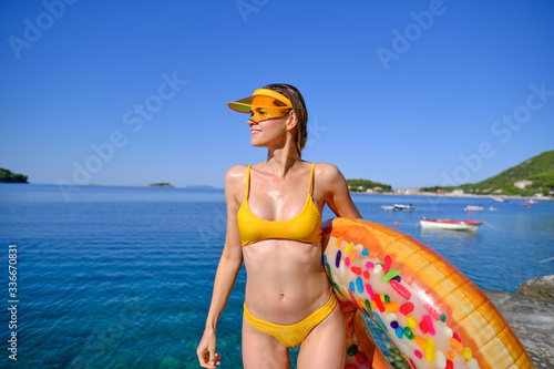 Sunny holiday. Woman with a air donut on the beach