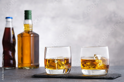 Glass with whiskey and ice cubes
