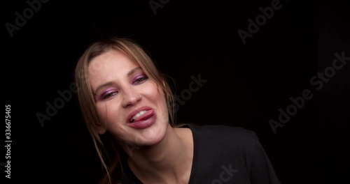 Woman showing his tongue to the camera, fooling around