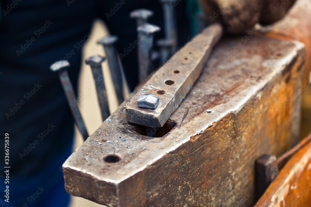 blacksmith working with a hammer	