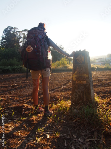 Pilgrim standing towards the sunrise, Camino de Santiago, Way of St. James, Journey from Teo to Santiago de Compostela, Portuguese way, Portugal