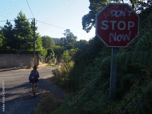 Pilgrim and road sign with written 