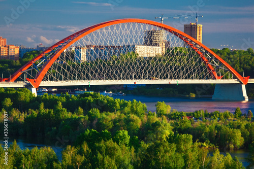 bugrinskiy bridge with red arch in novosibirsk in summer photo