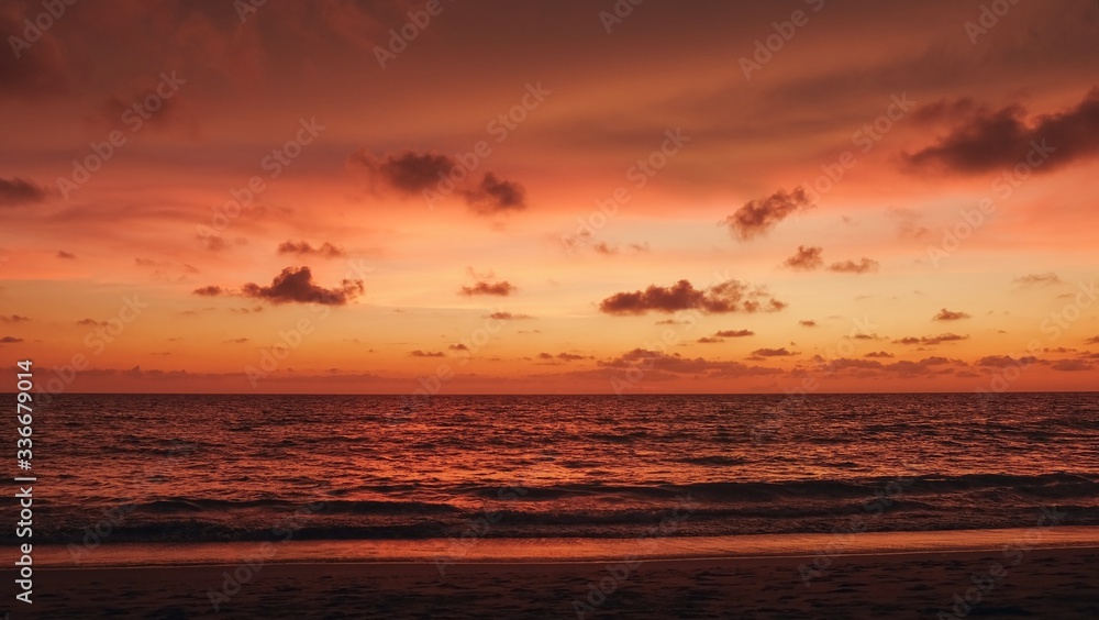 Stunning sunset with amazing red-orange colored heaven and dark fluffy clouds over Indian ocean.
Abstract blurred dramatic sunset with fantastic natural colors.