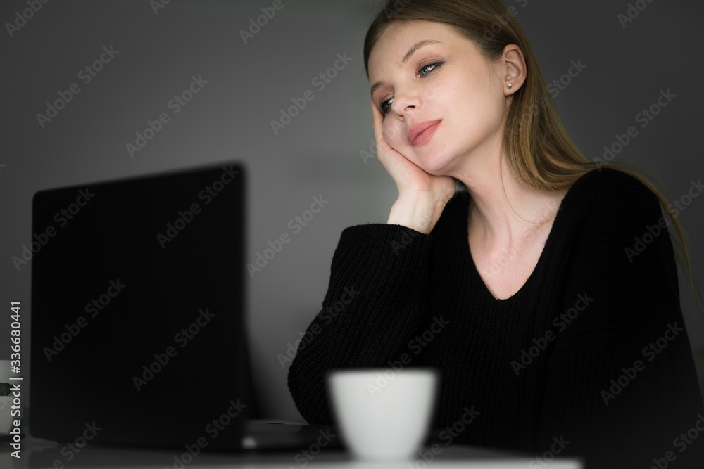 Front view of woman looking at laptop. Telework. Home working late at night.