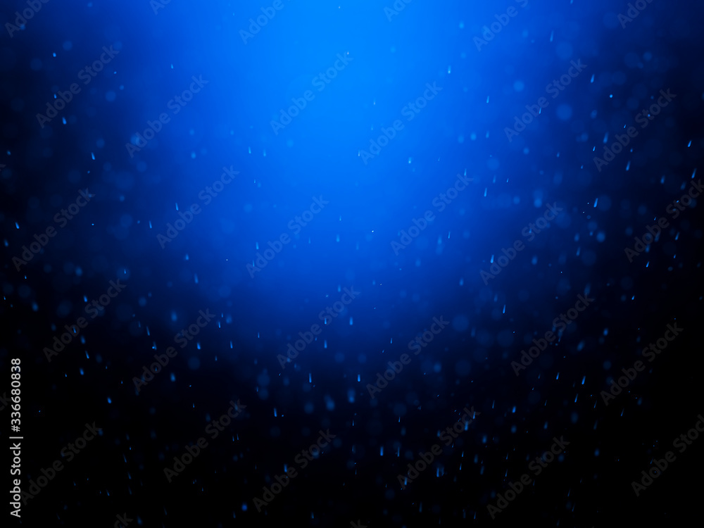 Blue bokeh on a dark background. Blur the background and wallpaper