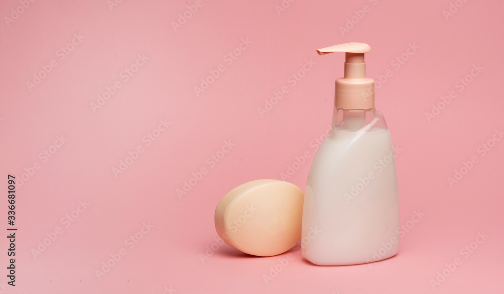 soap and a bottle of cream soap on a pink background. personal hygiene products for hand washing, copy space soap and a bottle of cream soap on a pink background. personal hygiene products for hand washing, copy space