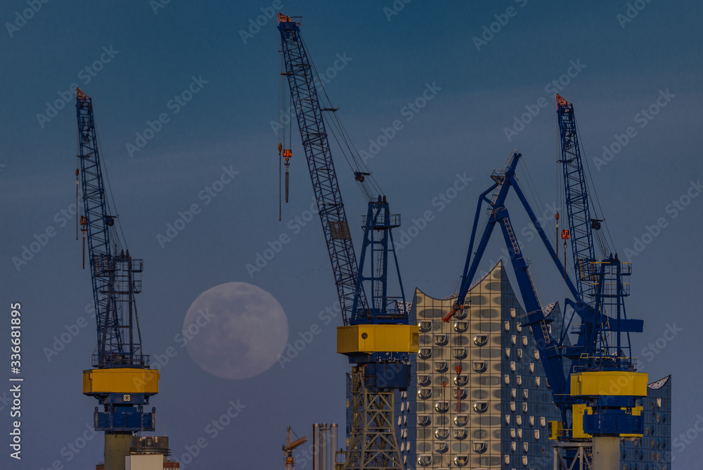 Full moon in Hamburg in the harbour over the Elbphilharmonie Full moon in Hamburg in the harbour over the Elbphilharmonie