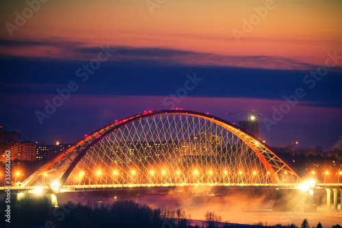 Illumination of Bugrinskiy bridge on the sunset, Novosibirsk, Siberia