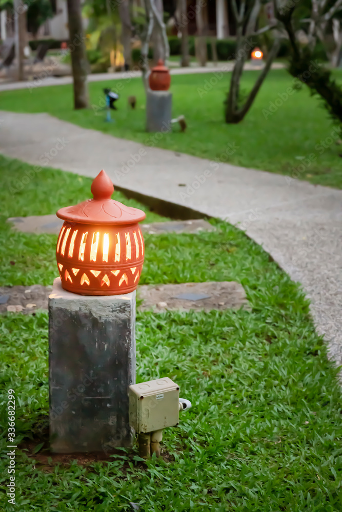 a glowing lantern in the evening by the path in the green Park om. evening a glowing lantern in the evening by the path in the green Park om. evening