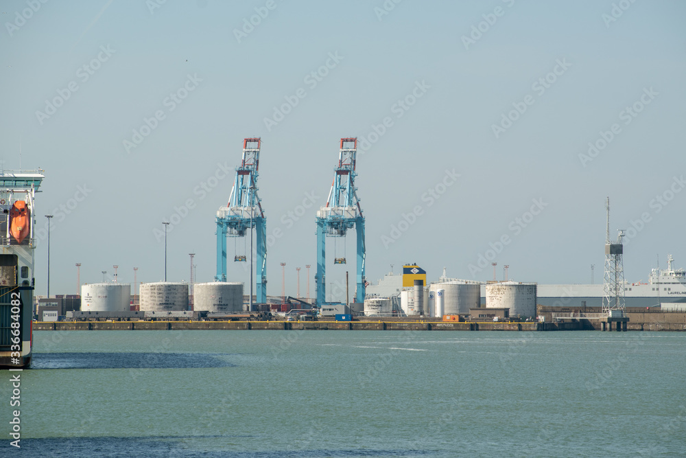 Cranes and silos at the entrance of the port in Zeebrugge, Belgium