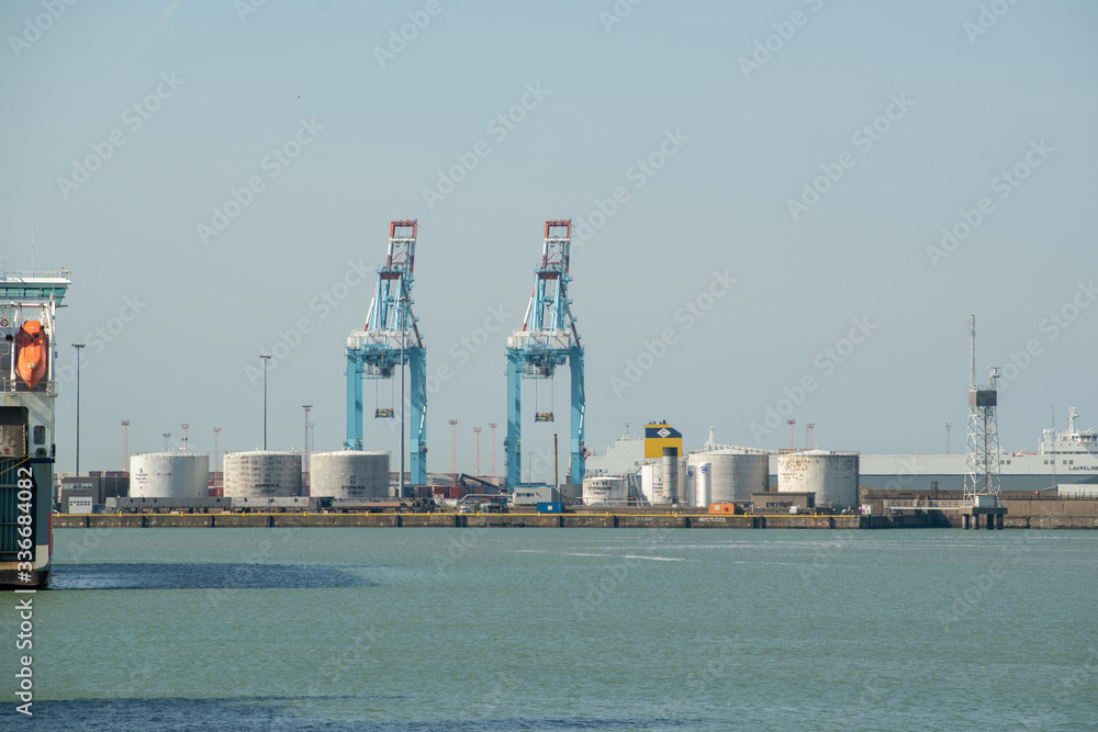 Cranes and silos at the entrance of the port in Zeebrugge, Belgium Cranes and silos at the entrance of the port in Zeebrugge, Belgium