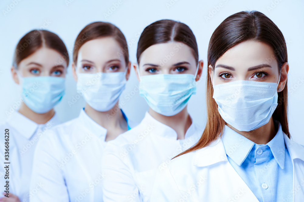 Masked young female doctor on an isolated white background Masked young female doctor on an isolated white background