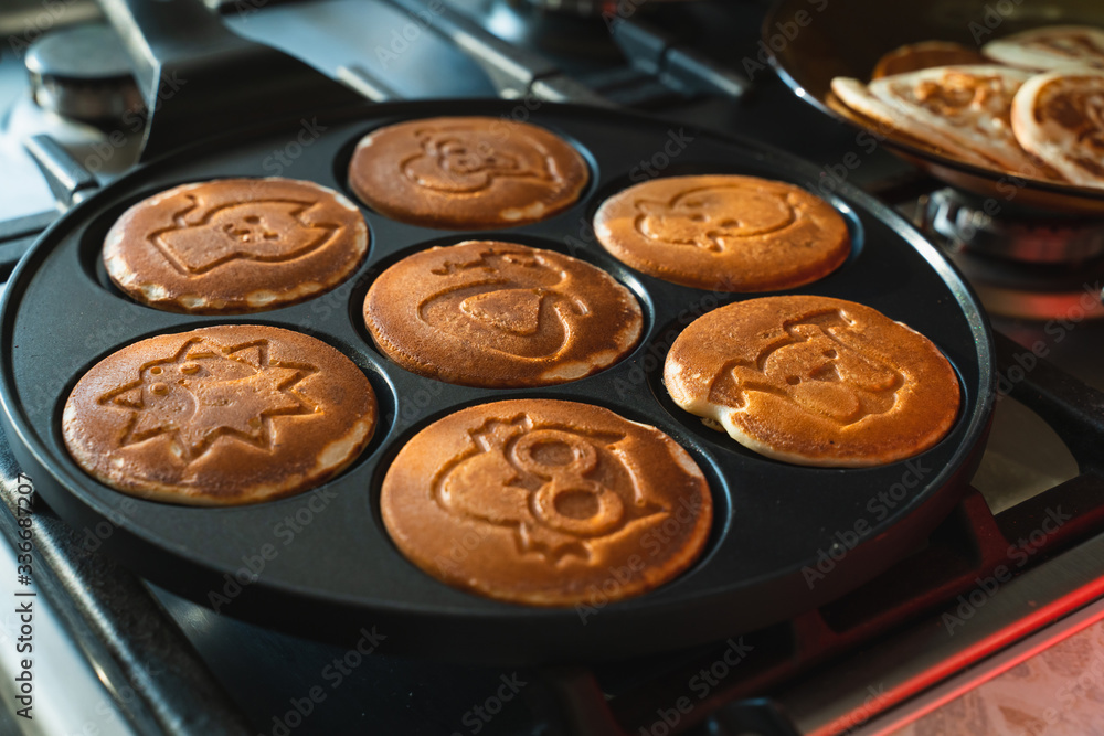 rosy pancakes on a frying pan. The process of cooking food rosy pancakes on a frying pan. The process of cooking food