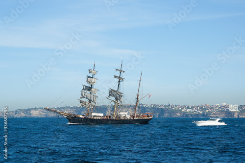 Sydney Australia, view of old schooner and speed boat off coast