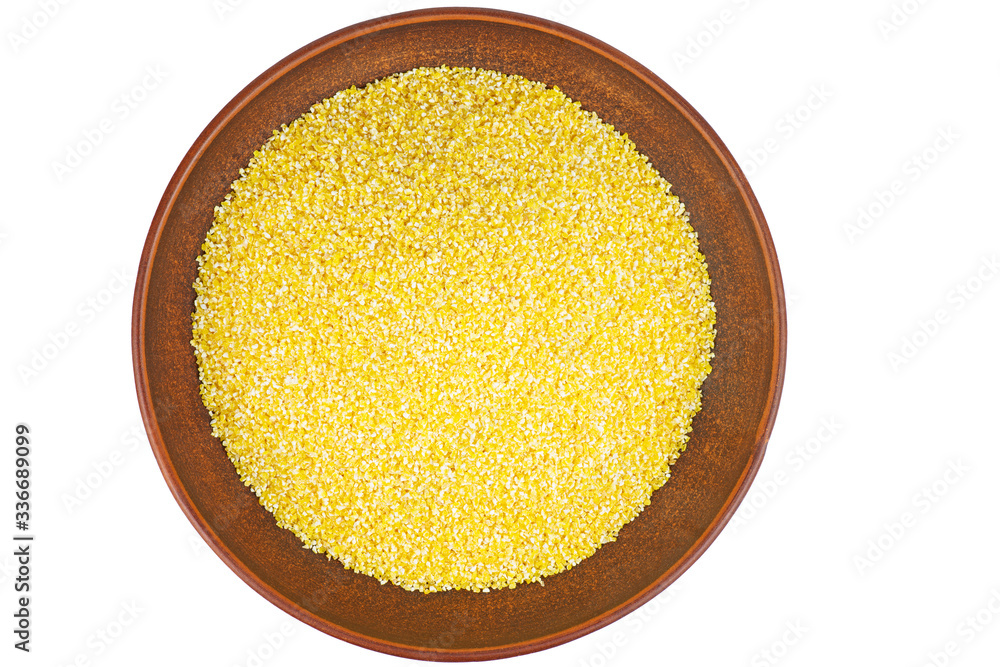 Corn groats in clay bowl isolated on white background Corn groats in clay bowl isolated on white background