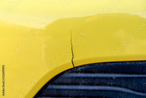 scratched car with damaged paint in crash accident or parking lot