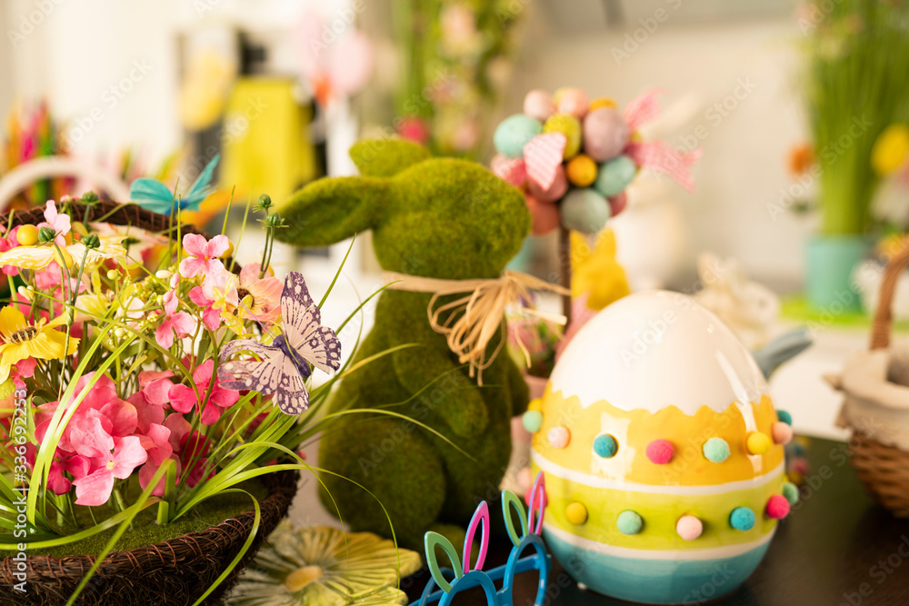 Easter theme. Easter decorations. Easter eggs in basket and easter bunny. Bouquet of spring flowers.