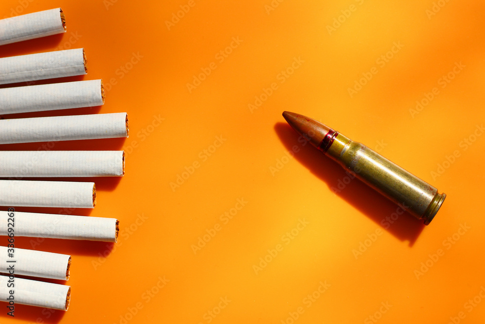 Cigarettes and bullet, metaphor for killing the body with nicotine
