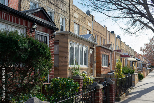 A Row of Old Brick Homes along the Sidewalk in Astoria Queens of New York City