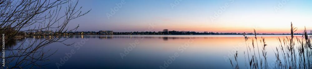 A panorama photo during the Blue hour on a allmost windless evening with a smooth lake Zoetermeerse Plas, Netherlands A panorama photo during the Blue hour on a allmost windless evening with a smooth lake Zoetermeerse Plas, Netherlands
