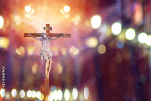 Leinwand Poster crucifix, jesus on the cross in church with ray of light from stained glass, eas