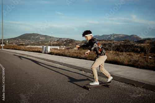 Portrait Guy with style and modern with a longboard in the street